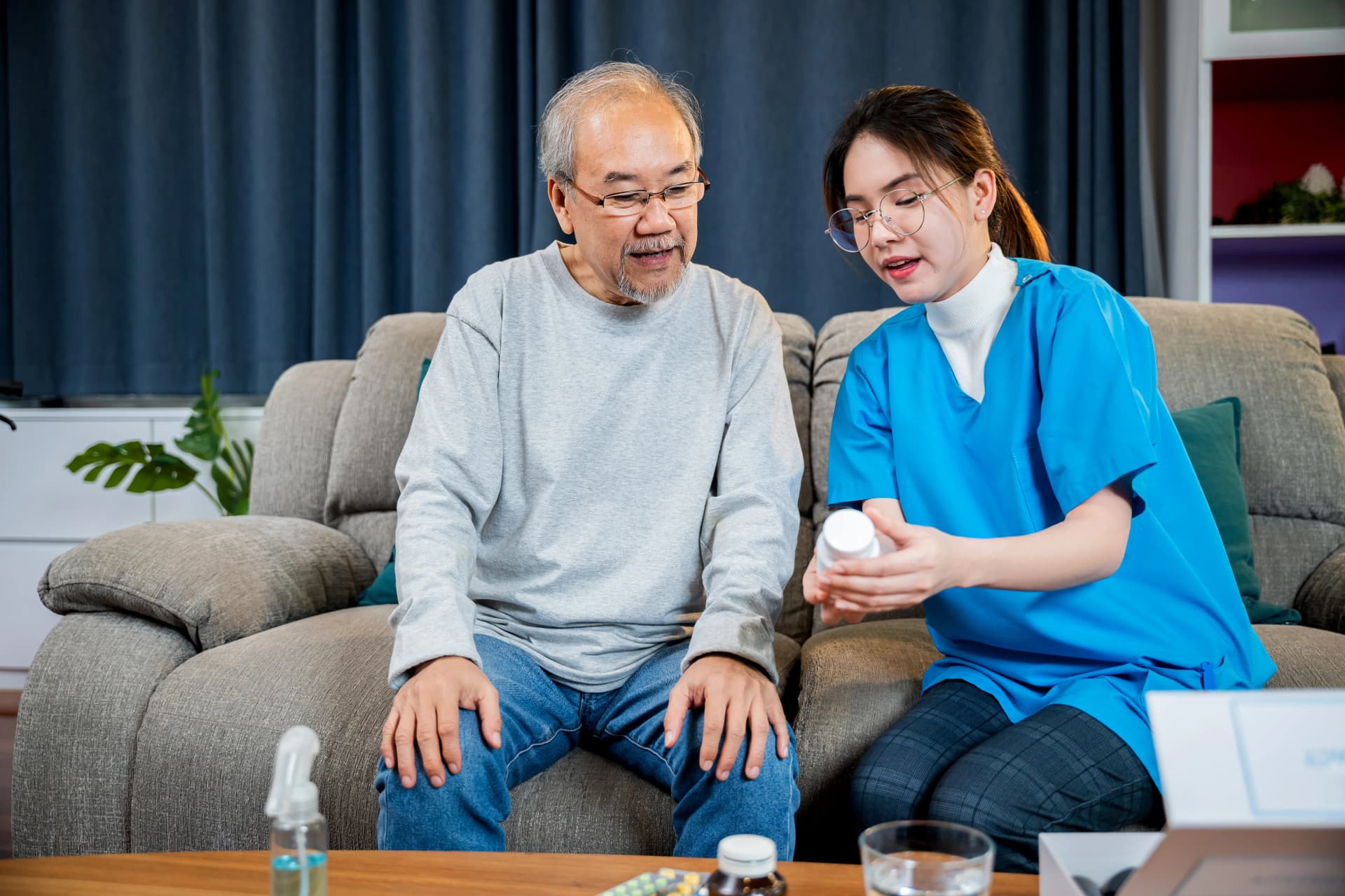 Asian nurse helping senior woman