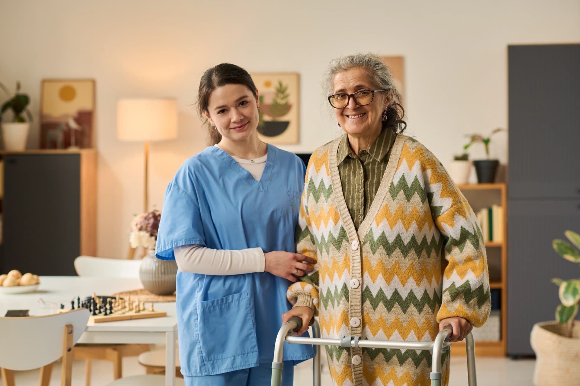 Smiling woman comforting senior woman on sofa